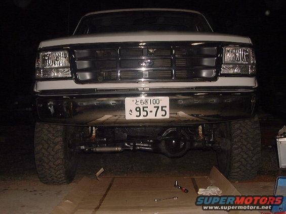 White Ford Bronco front view, chrome grille, large tires, Japanese license plate